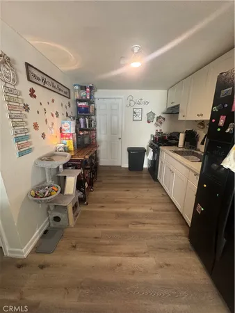 a kitchen with granite countertop a sink appliances and cabinets