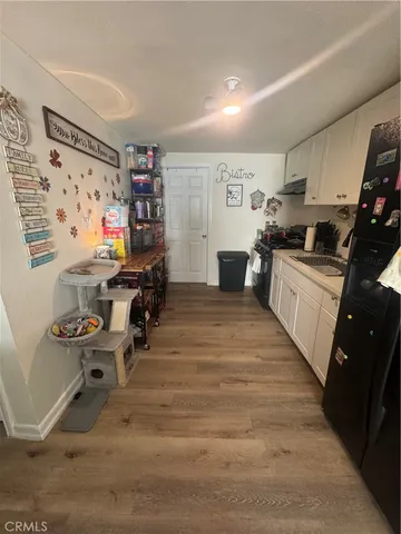 a kitchen with granite countertop a sink appliances and cabinets