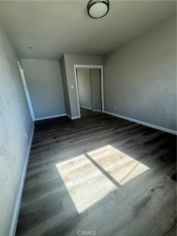 a view of an empty room and wooden floor