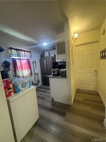 a view of kitchen with furniture wooden floor and window