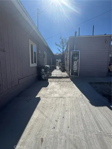 a spacious bedroom with a bed and wooden floor