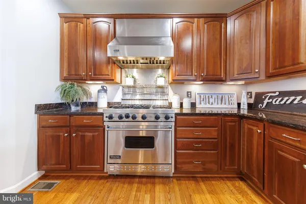 a kitchen with stove and cabinets