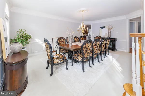 a view of a dining room with furniture and chandelier