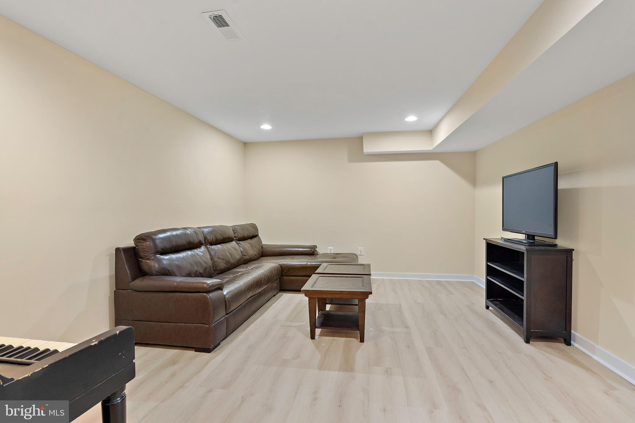 132 Hilltop Road Silver Spring, MD 20910 - Photo 32 of 50 a living room with furniture and a flat screen tv