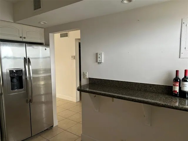 a kitchen with a refrigerator and cabinets