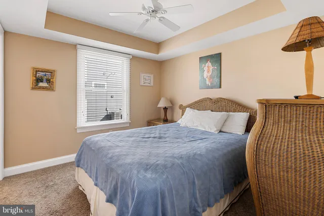 a bedroom with two beds and a chandelier