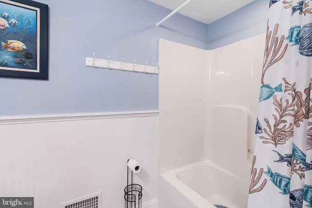 a bedroom with bed and a chandelier