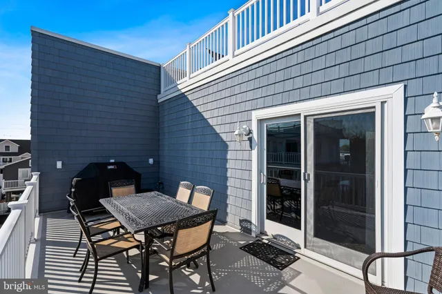 a view of a terrace with a table and chairs