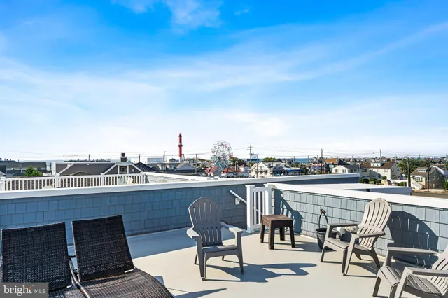 a living room with furniture a flat screen tv and a large window