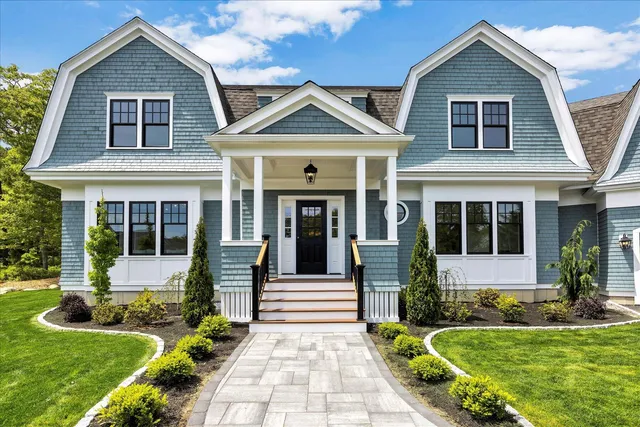 a front view of a house with a yard