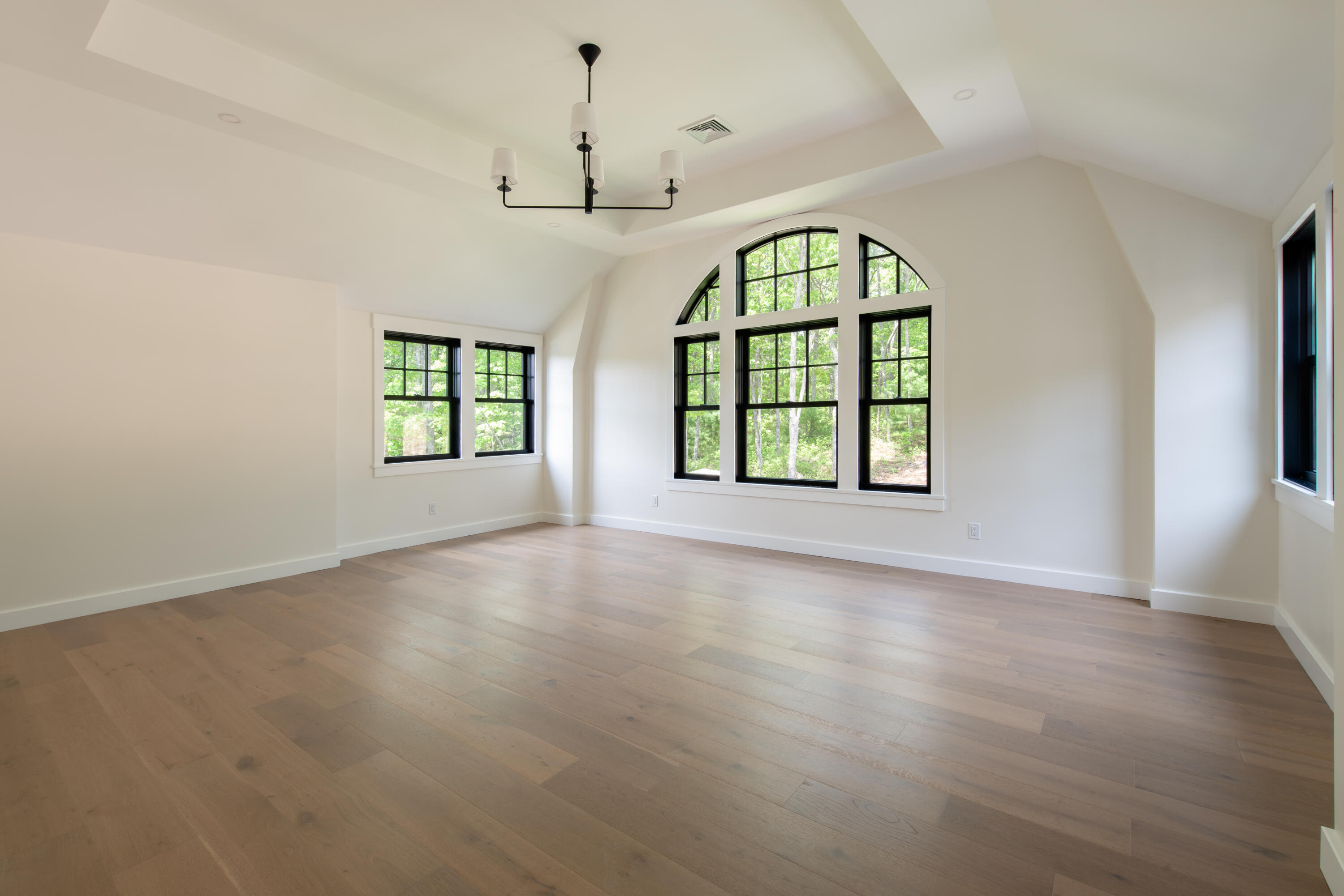 61 McKenna Ridge Drive East Falmouth, MA 02536 - Photo 22 of 44 an empty room with wooden floor windows and fireplace