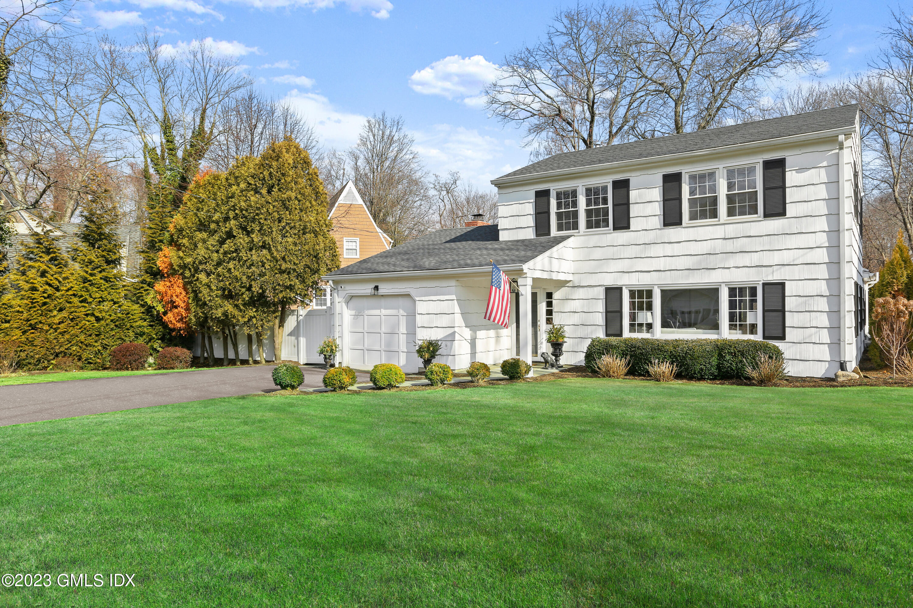 25 Manor Road Old Greenwich, CT 06870 - Photo 1 of 21 a front view of a house with a garden