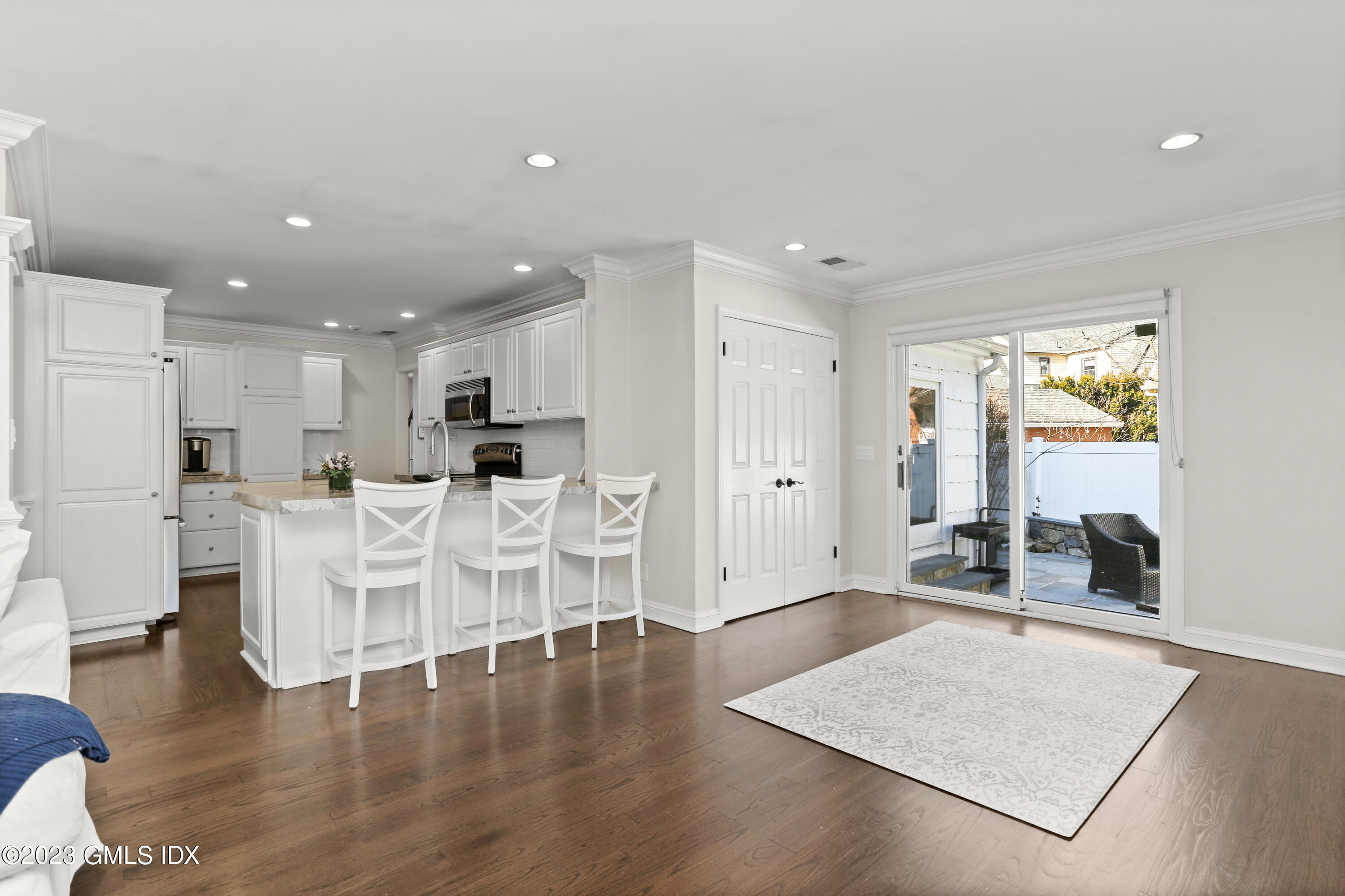 25 Manor Road Old Greenwich, CT 06870 - Photo 5 of 21 a living room with white cabinets and kitchen island with chair
