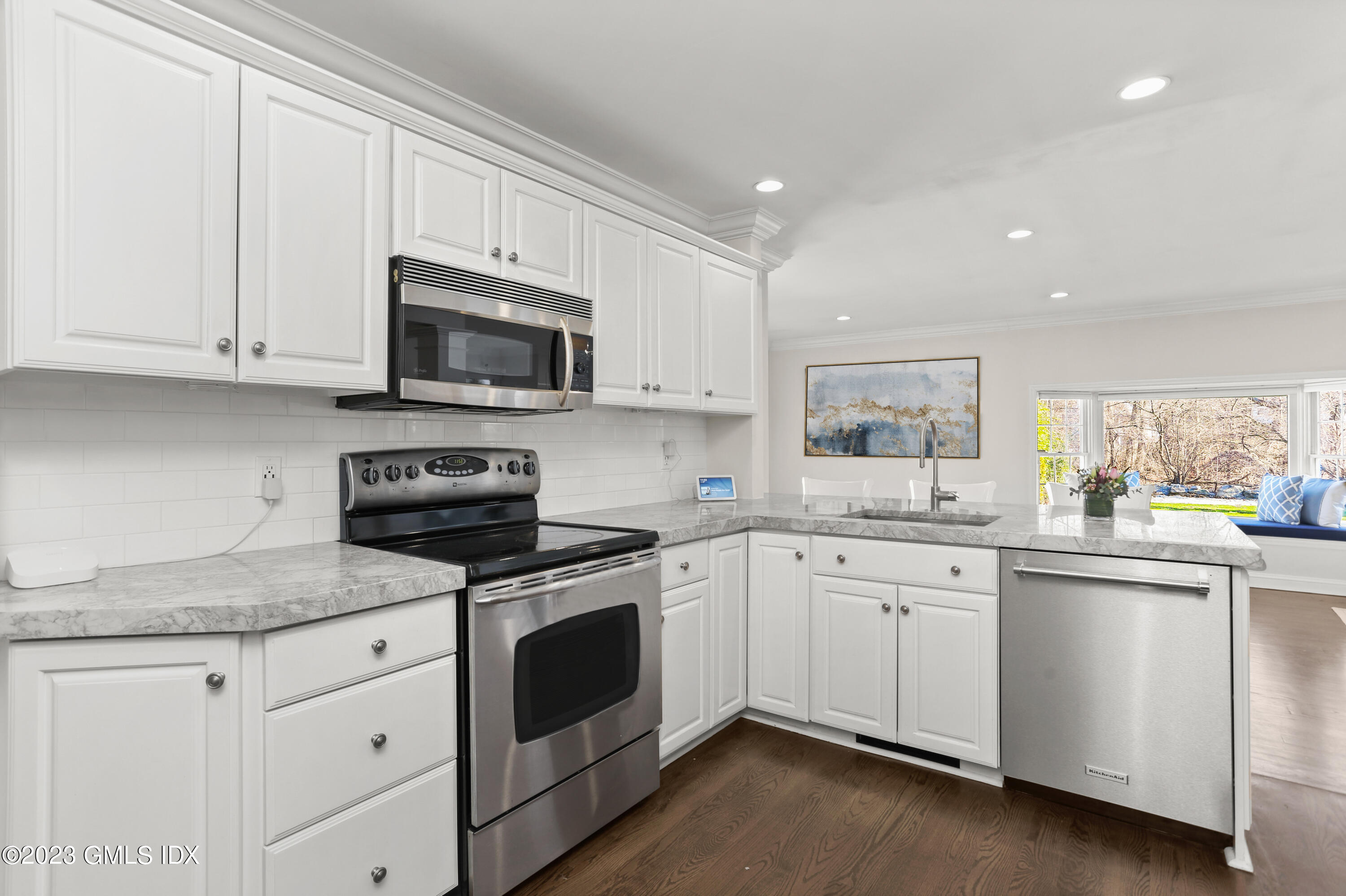 25 Manor Road Old Greenwich, CT 06870 - Photo 6 of 21 a kitchen with granite countertop white cabinets white stainless steel appliances with a sink and dishwasher