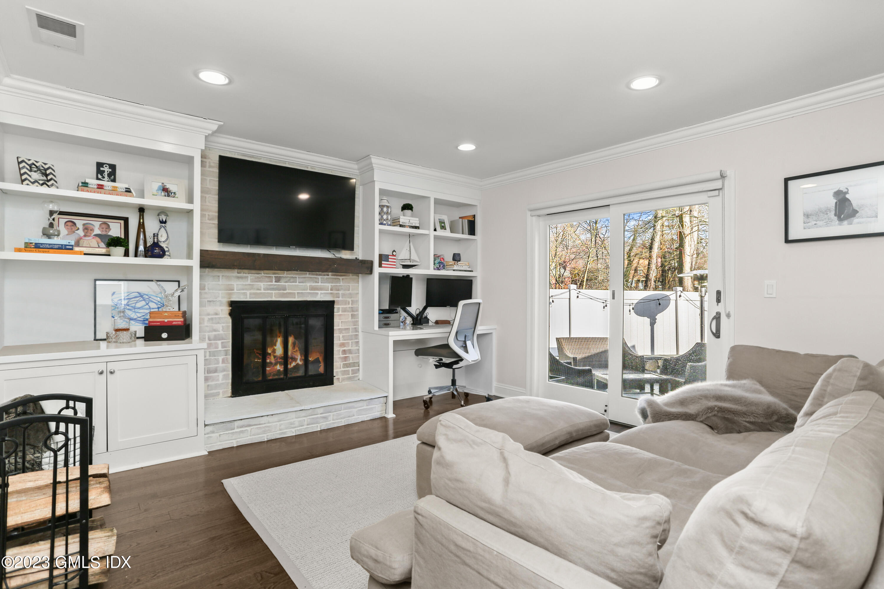 25 Manor Road Old Greenwich, CT 06870 - Photo 10 of 21 a living room with furniture or flat screen tv and a fireplace