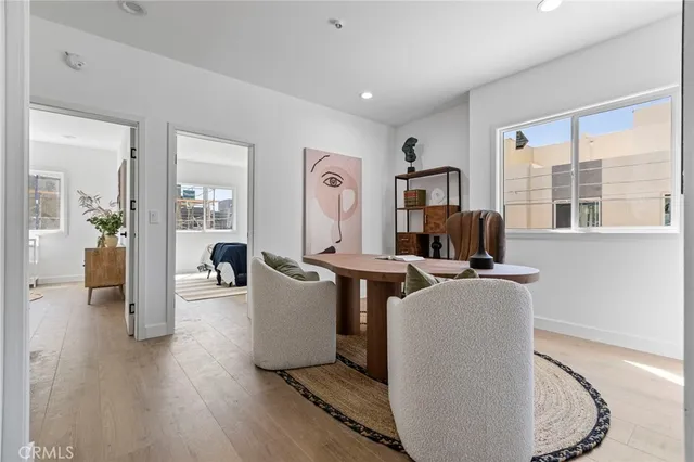 a living room with furniture a window and a wooden floor