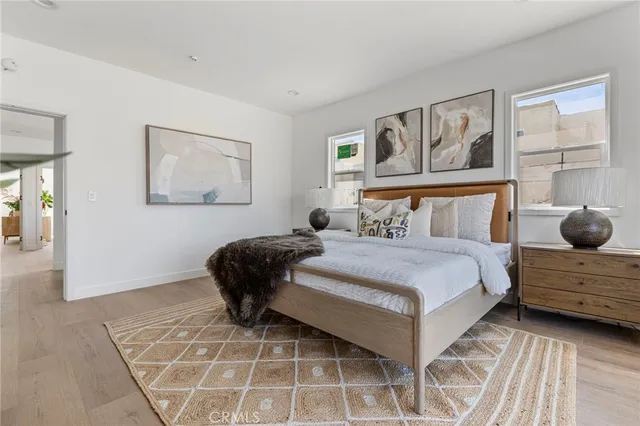 a bedroom with a bed and a painting on the wall