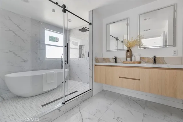 a bathroom with a tub sink and mirror