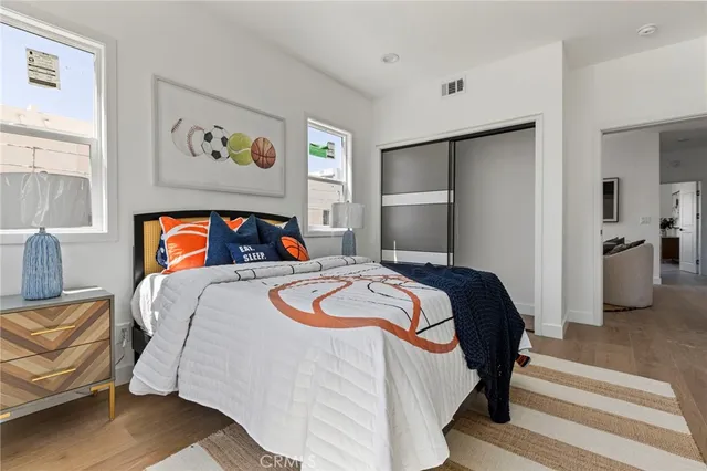 a bedroom with a bed and painting on the wall