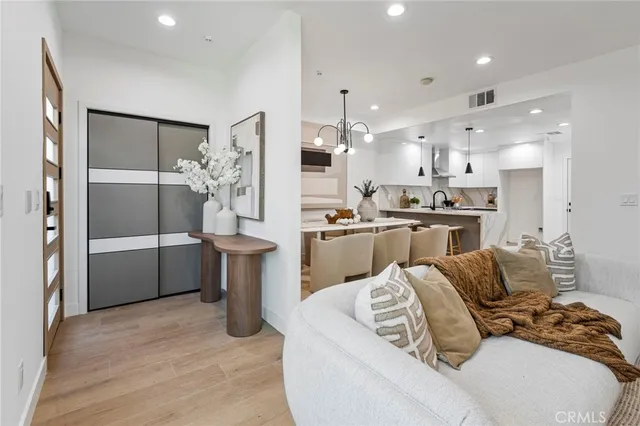 a kitchen with stainless steel appliances kitchen island granite countertop a refrigerator and a sink