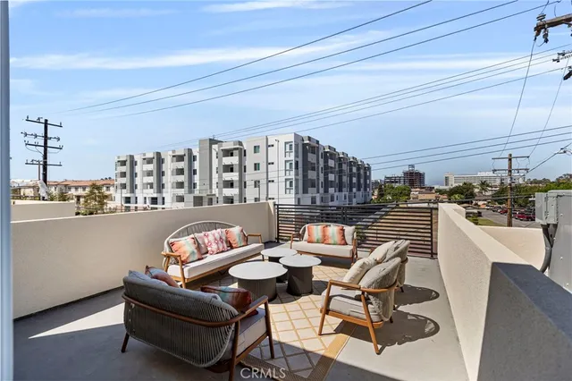 a living room with furniture and a kitchen view