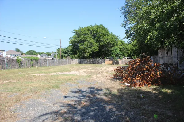 a view of a yard with yellow lighting
