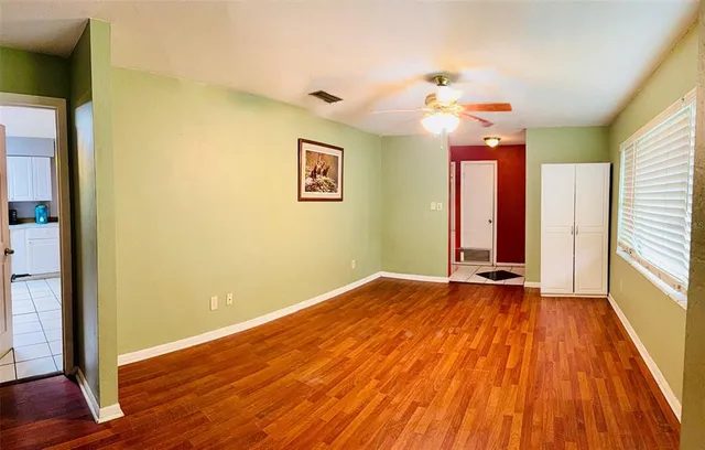 wooden floor in an empty room with a window