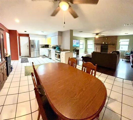 a kitchen with white cabinets and appliances