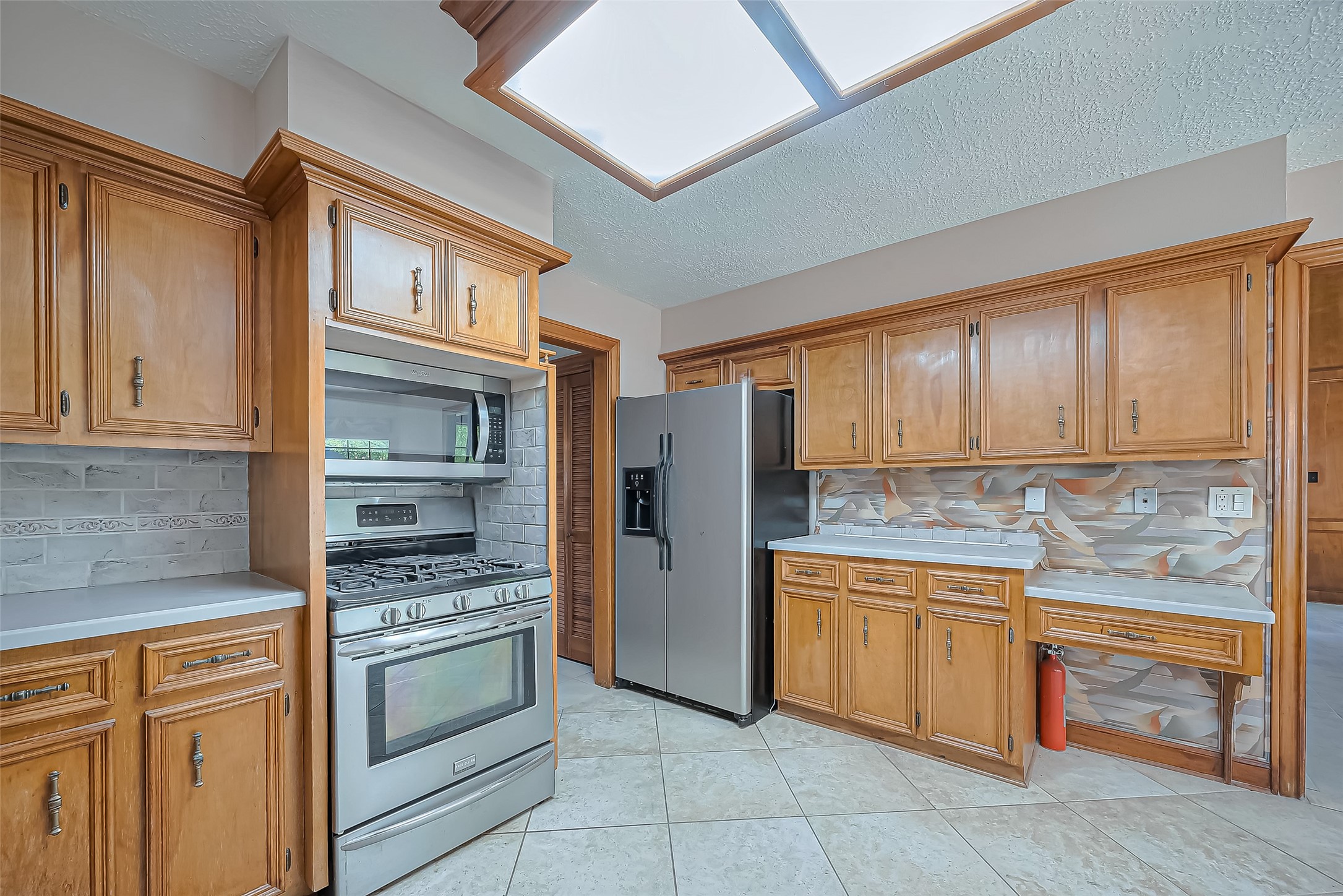 18307 Champion Forest Drive Spring, TX 77379 - Photo 14 of 49 a kitchen with a refrigerator sink and cabinets