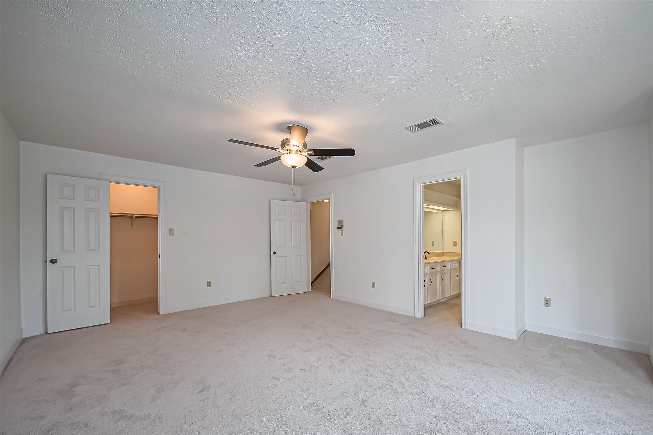 18307 Champion Forest Drive Spring, TX 77379 - Photo 19 of 49 a view of an empty room with a ceiling fan