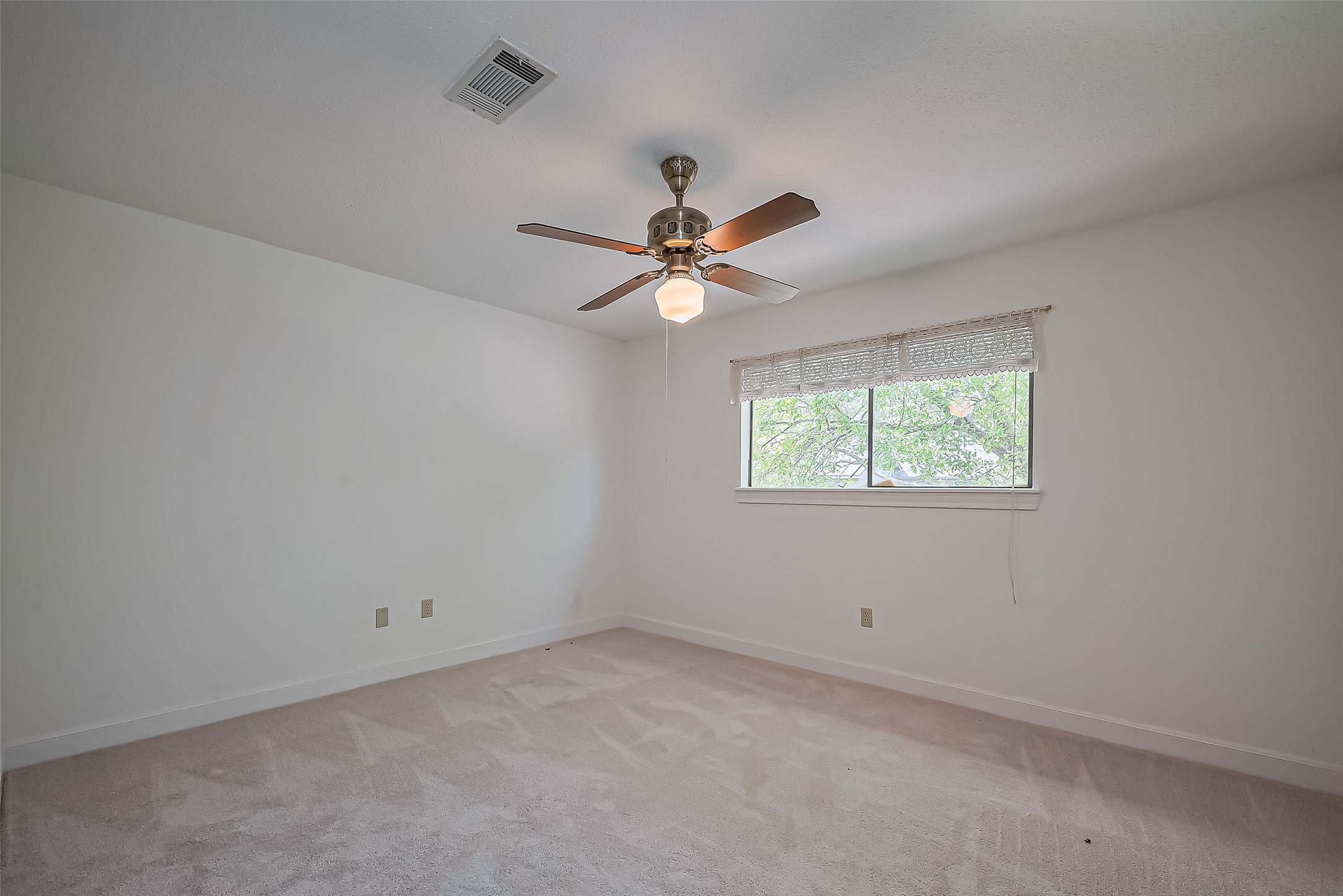 18307 Champion Forest Drive Spring, TX 77379 - Photo 26 of 49 an empty room with a window and a fan