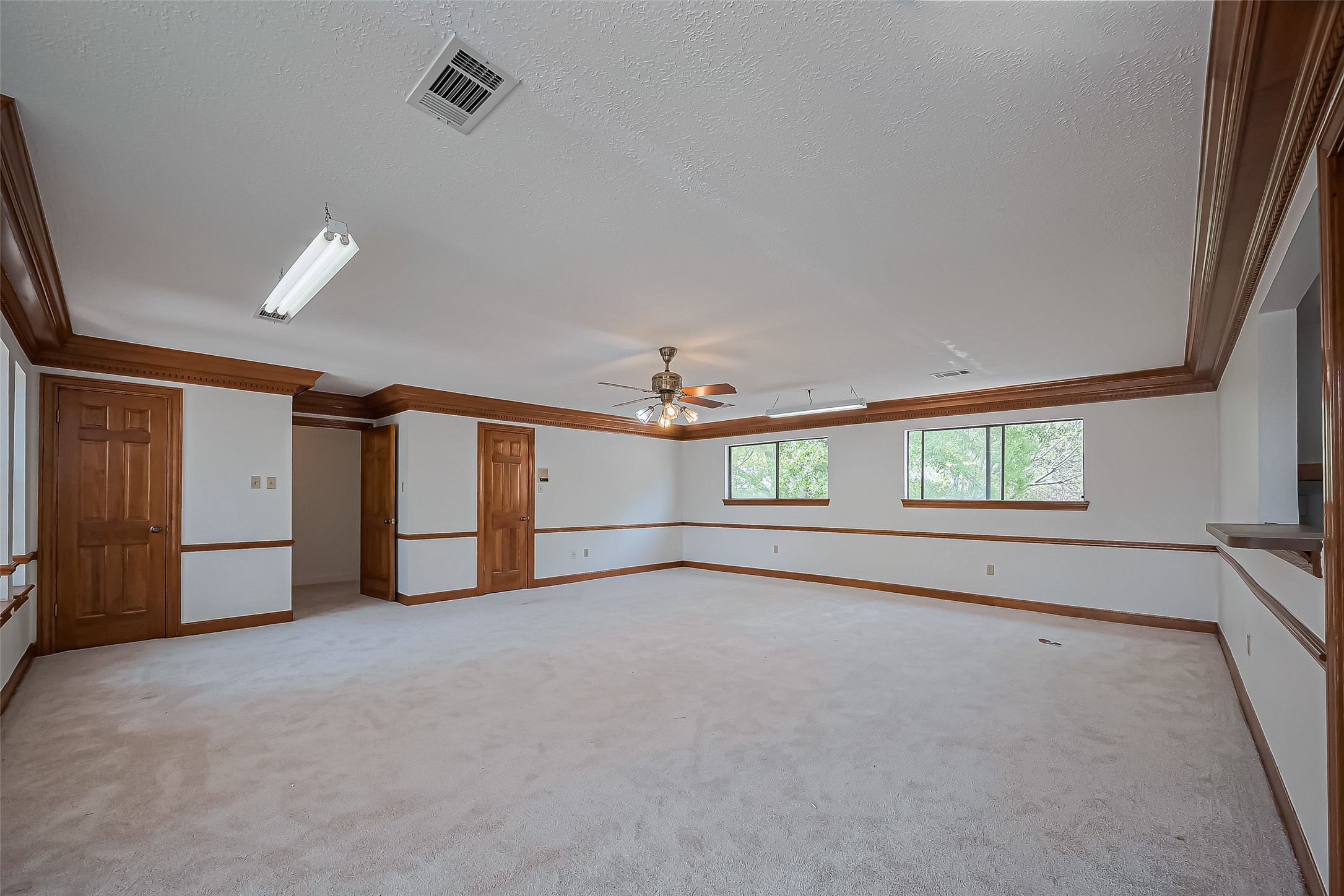 18307 Champion Forest Drive Spring, TX 77379 - Photo 32 of 49 an empty room with windows and ceiling fan