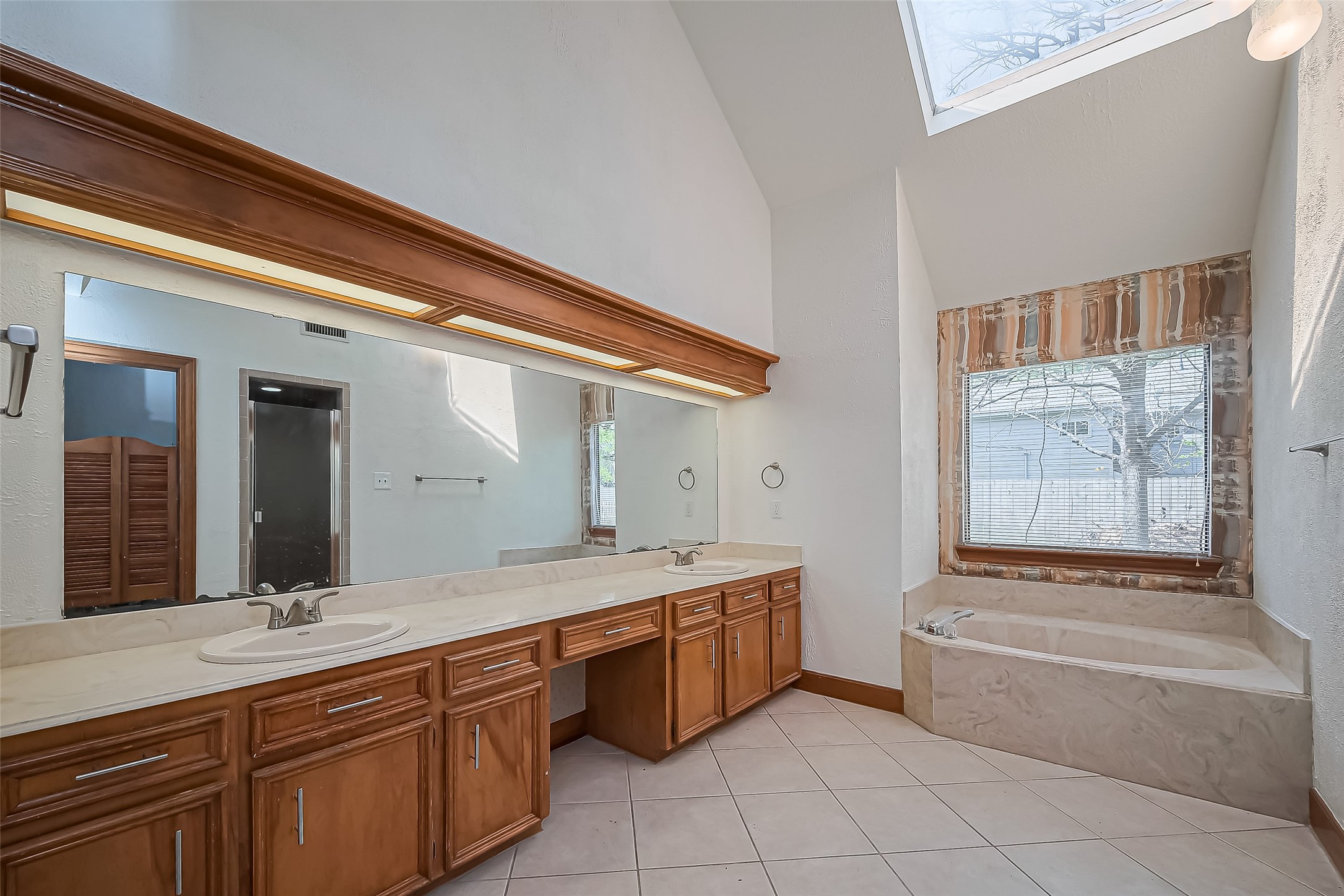 18307 Champion Forest Drive Spring, TX 77379 - Photo 39 of 49 a spacious bathroom with a granite countertop tub sink and mirror