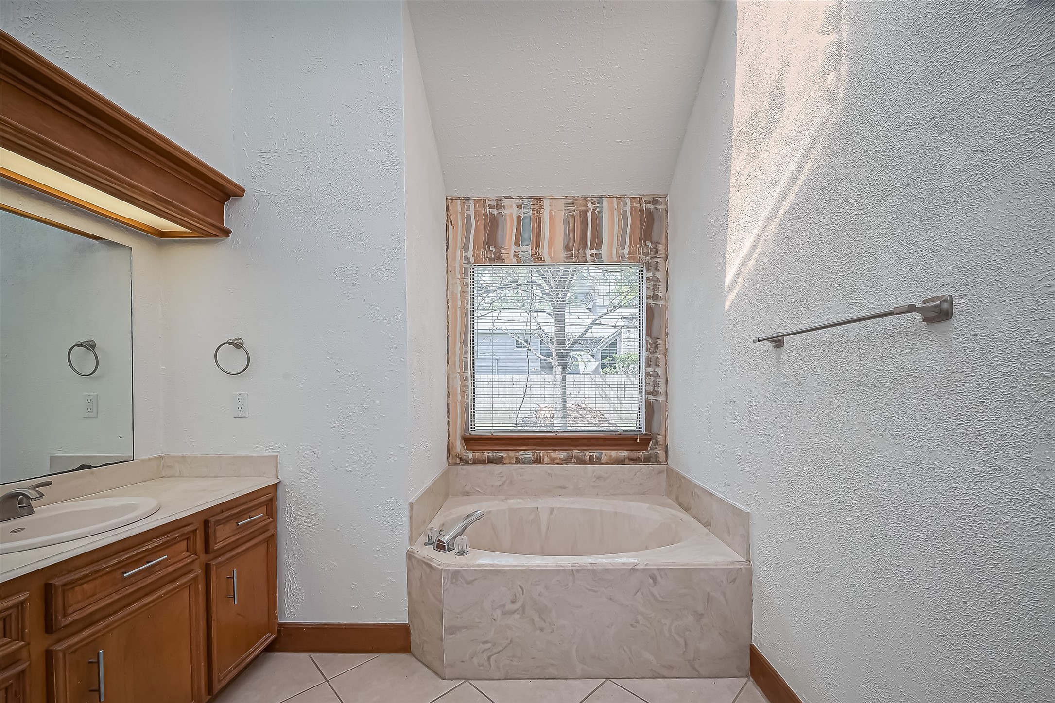 18307 Champion Forest Drive Spring, TX 77379 - Photo 40 of 49 a bath tub sitting in a bathroom next to a sink