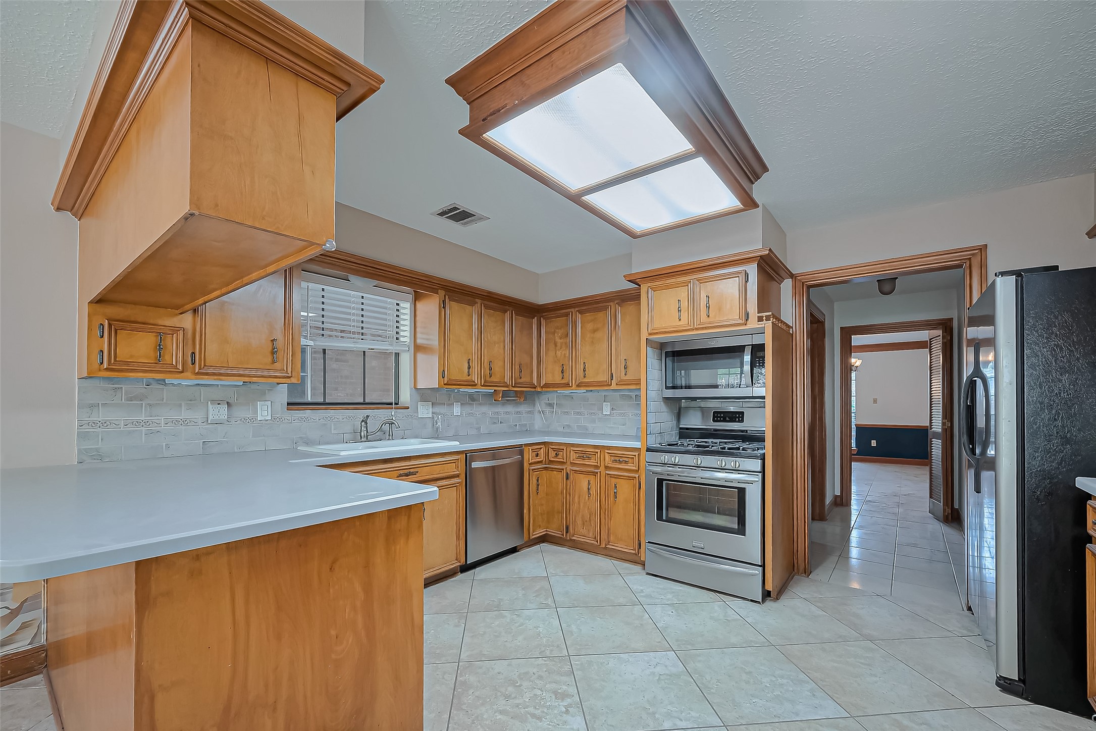 18307 Champion Forest Drive Spring, TX 77379 - Photo 10 of 49 a kitchen with stainless steel appliances granite countertop a sink and cabinets