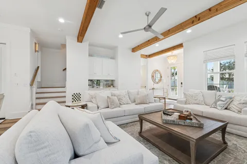 a bathroom with a toilet a sink and wooden floor