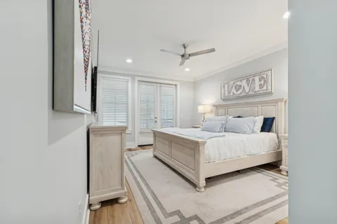 a bedroom with a large bed and a flat screen tv