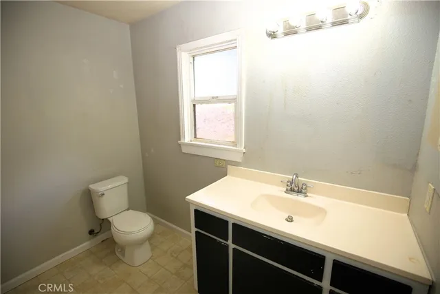 a bathroom with a sink mirror and toilet