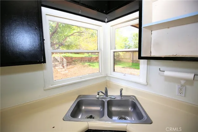 a bathroom with a sink window and tub