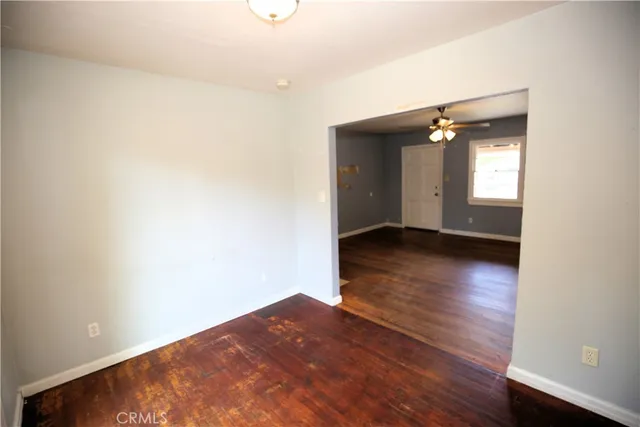 an empty room with wooden floor and closet
