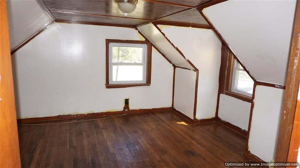 322 Beulah Road Pittsburgh, PA 15235 - Photo 16 of 22 a view of an empty room with wooden floor and a window