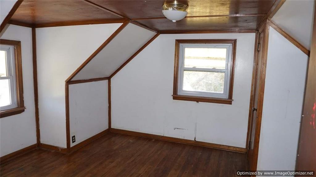 322 Beulah Road Pittsburgh, PA 15235 - Photo 17 of 22 a view of an empty room with wooden floor and a window