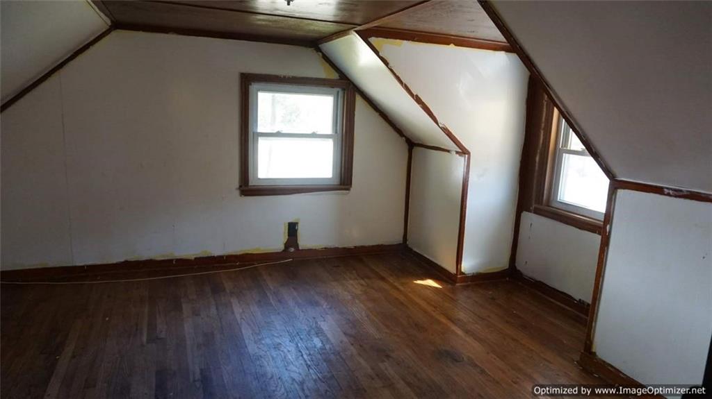 322 Beulah Road Pittsburgh, PA 15235 - Photo 18 of 22 a view of an empty room with wooden floor and a window