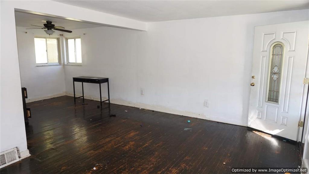 322 Beulah Road Pittsburgh, PA 15235 - Photo 4 of 22 an empty room with wooden floor and windows