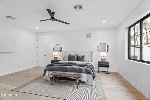 a bedroom with a bed and a chandelier