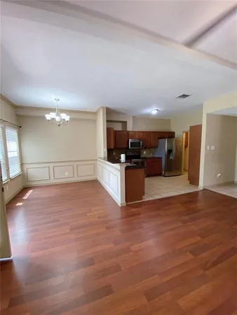 a view of a kitchen with a sink and a refrigerator
