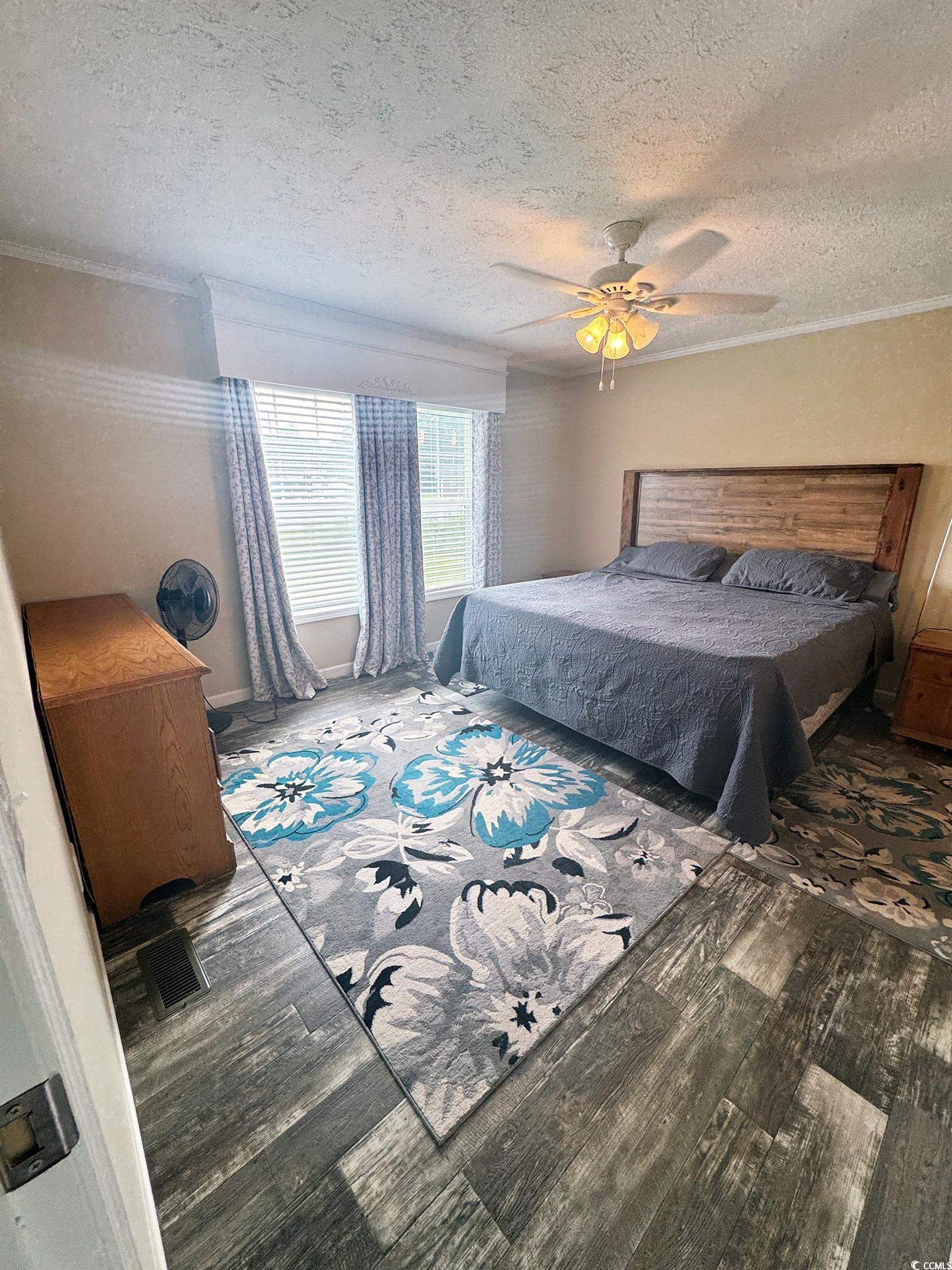 2620 Red Bluff Road Loris, SC 29569 - Photo 19 of 33 Bedroom with wood finished floors, a textured ceil