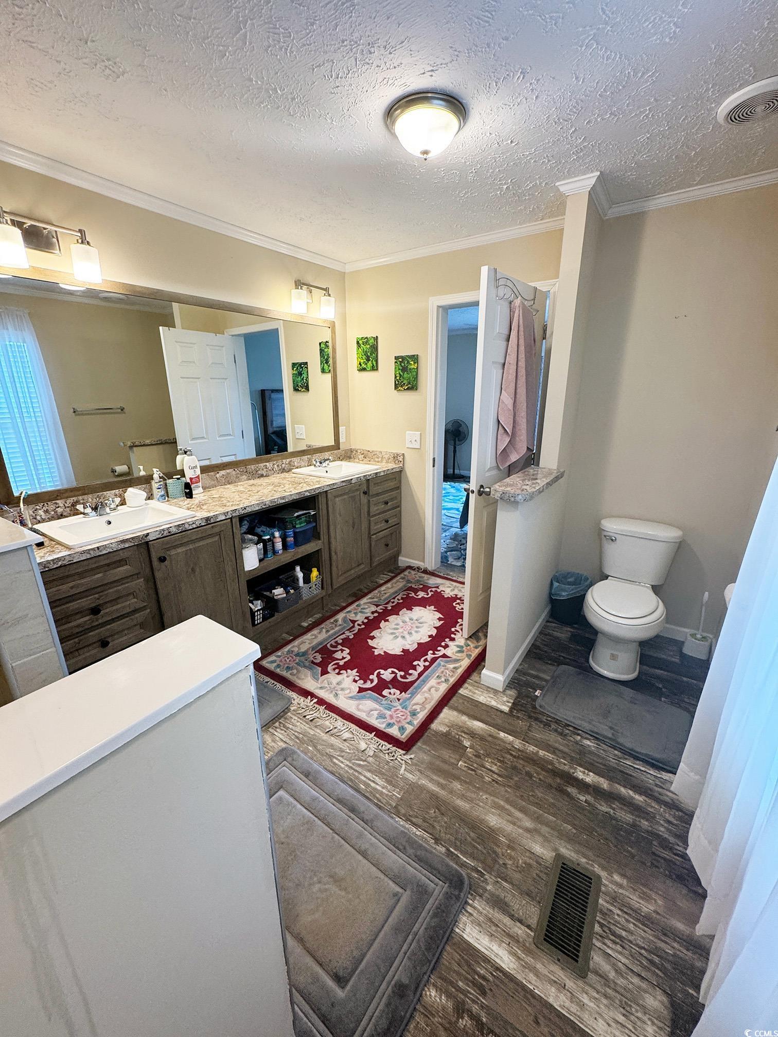 2620 Red Bluff Road Loris, SC 29569 - Photo 24 of 33 Bathroom with ornamental molding, wood finished fl