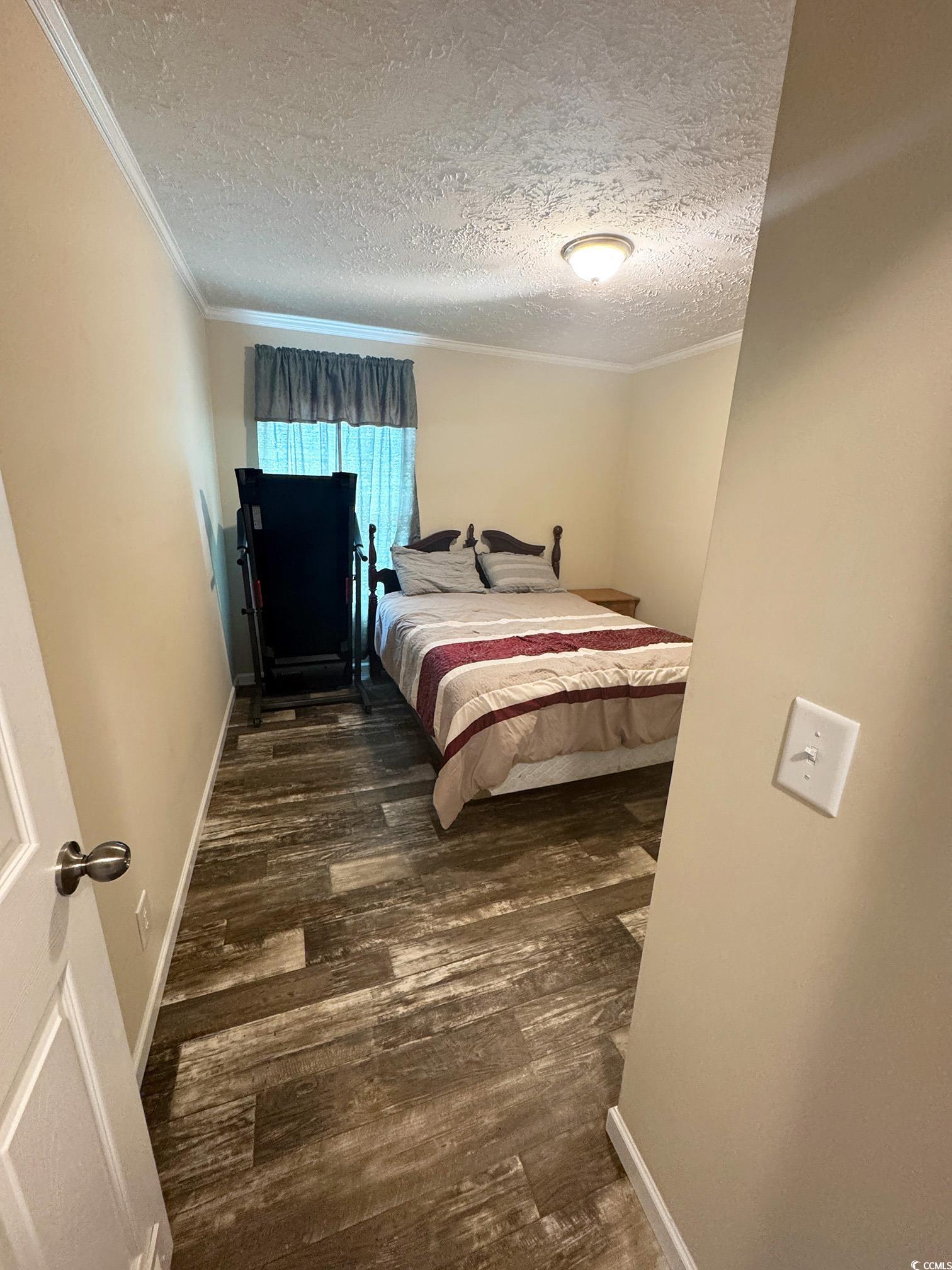 2620 Red Bluff Road Loris, SC 29569 - Photo 27 of 33 Bedroom with wood finished floors, a textured ceil