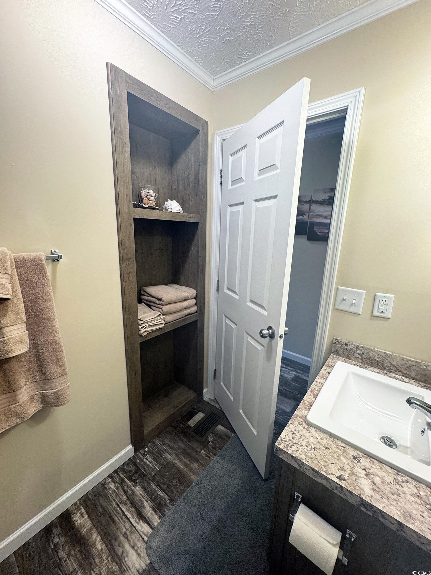2620 Red Bluff Road Loris, SC 29569 - Photo 29 of 33 Bathroom with vanity, crown molding, and wood fini